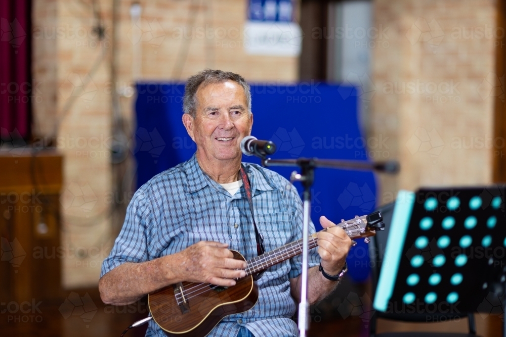 older gentleman playing ukulele - Australian Stock Image