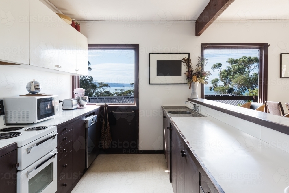 Older style retro 70s kitchen in Australian beach house with a view - Australian Stock Image