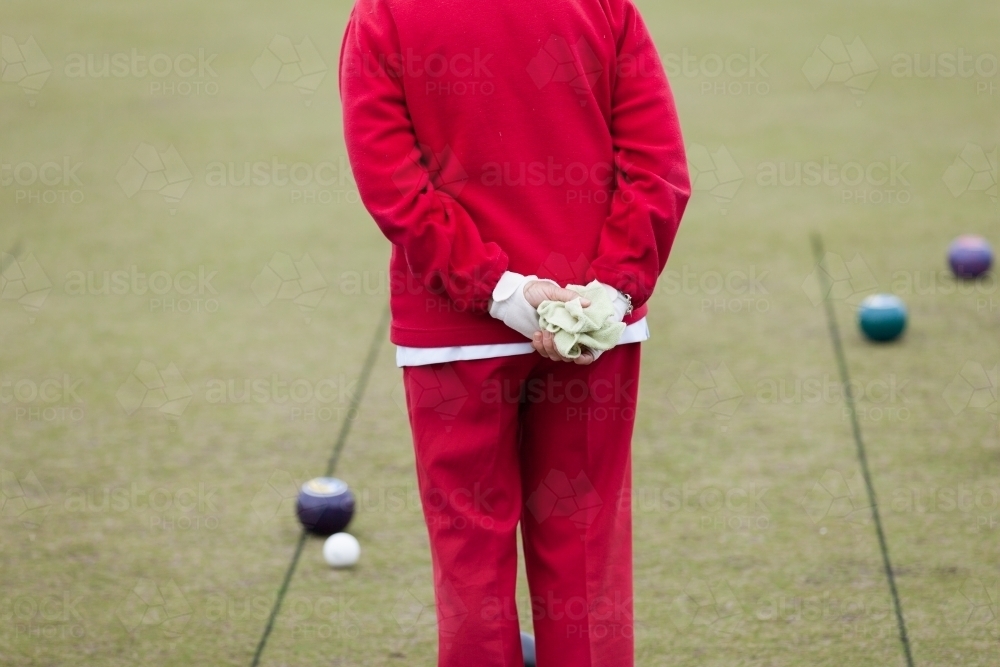 Older woman watching lawn bowls - Australian Stock Image