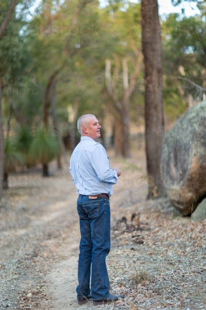 One man standing on a bush track - Australian Stock Image