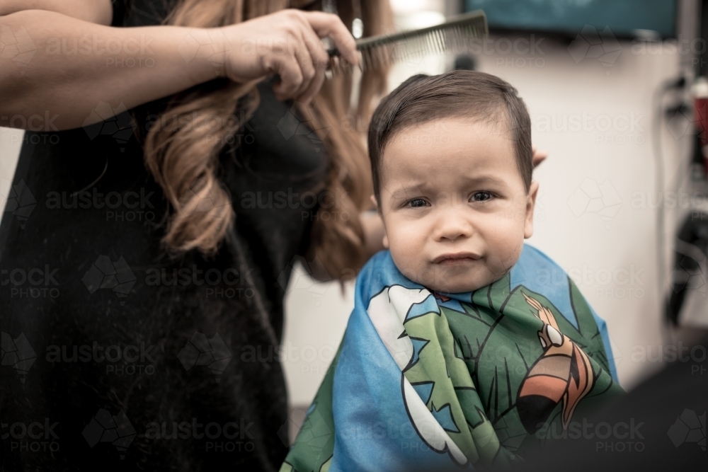 One year old mixed race baby boy has his first haircut - Australian Stock Image