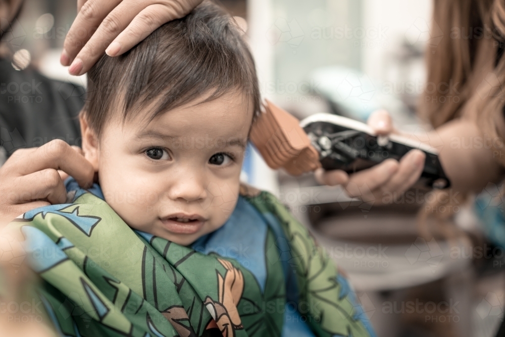 One year old mixed race baby boy has his first haircut - Australian Stock Image
