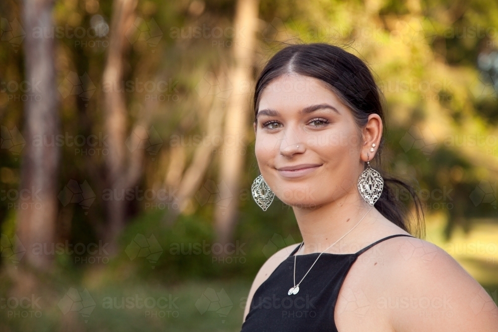 One young lady looking at camera smiling - Australian Stock Image