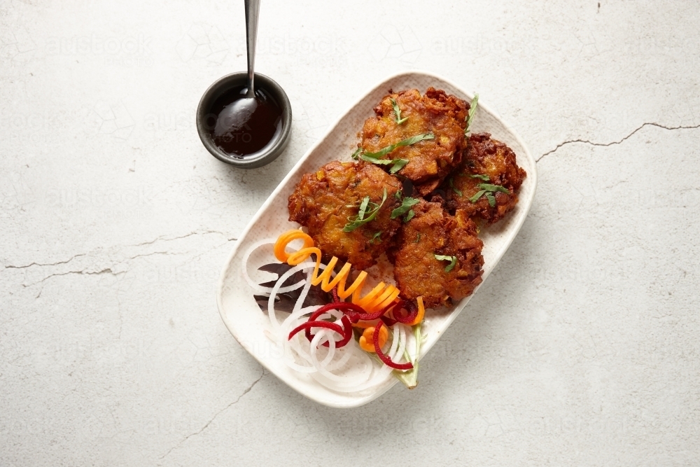Onion bhaji dish on table - Australian Stock Image