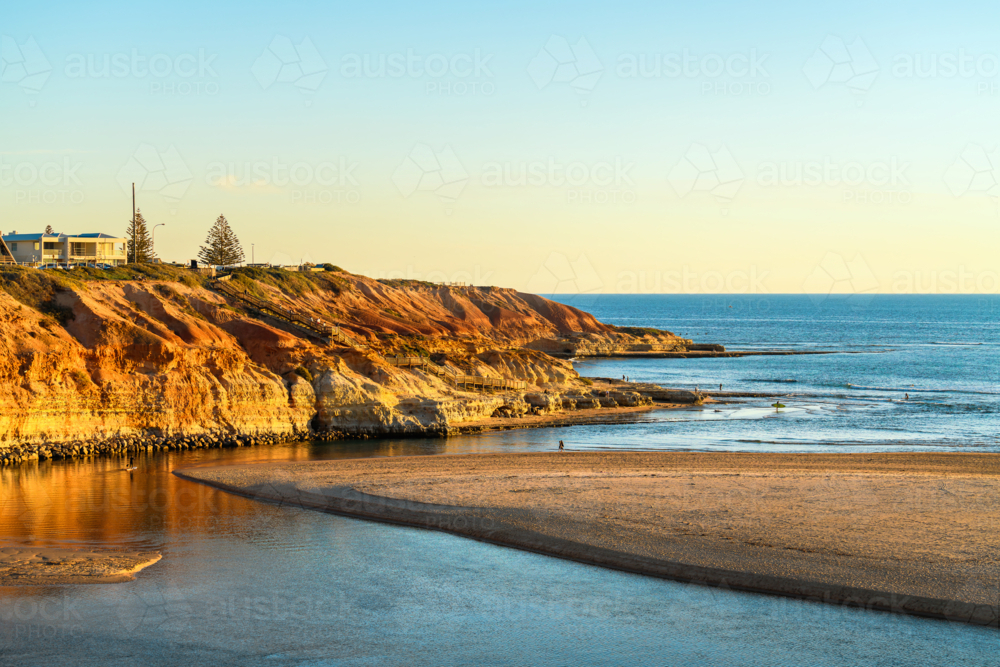 Onkaparinga River mouth with people walking around at sunset, South Port Beach, South Australia - Australian Stock Image