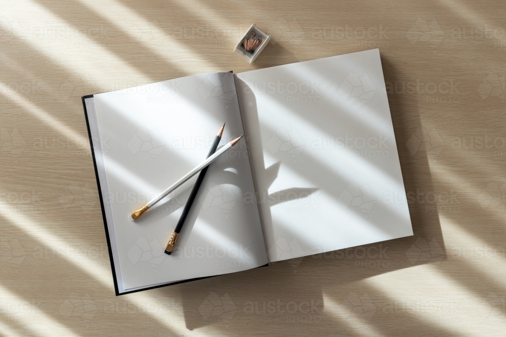 open book with blank pages and pencils - Australian Stock Image