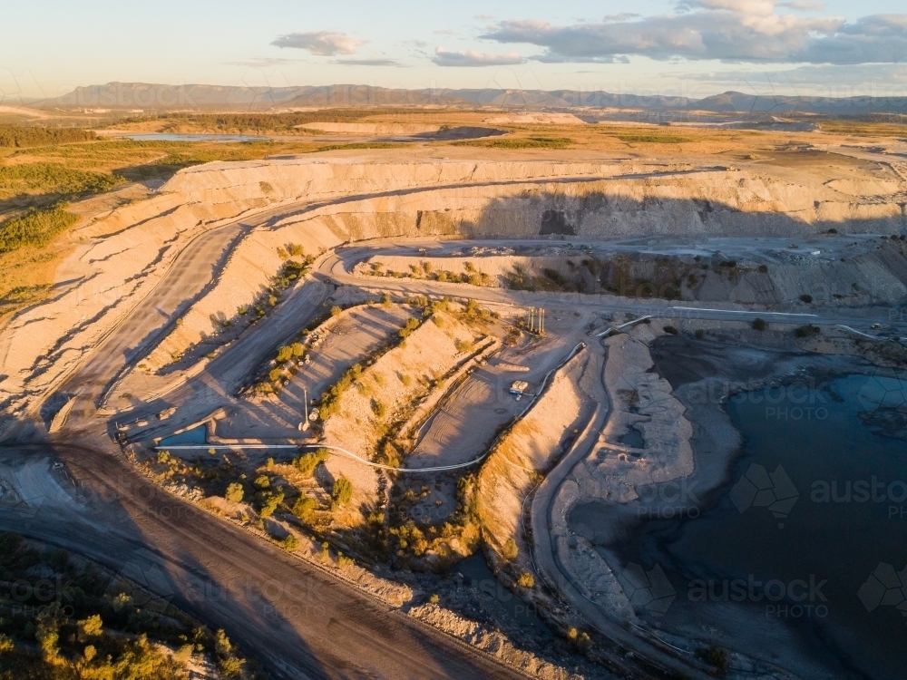 open cut coal mine in Bulga area of the Hunter Valley in the evening - Australian Stock Image