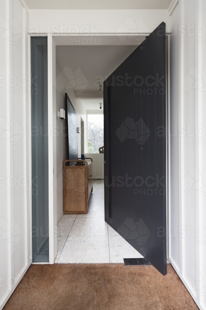 Open front pivot style door to a luxury Australian home - Australian Stock Image