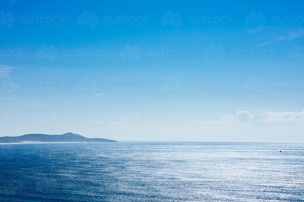 Open seas and a distant northern headland at Crescent Head - Australian Stock Image