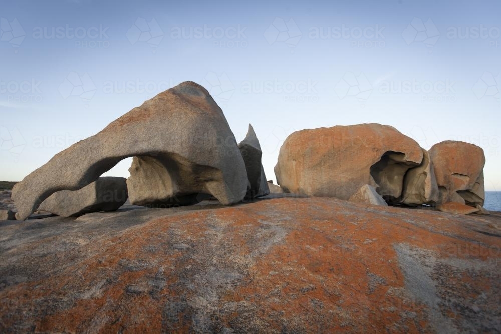 Orange and red stone of the Remarkable Rocks against sky - Australian Stock Image