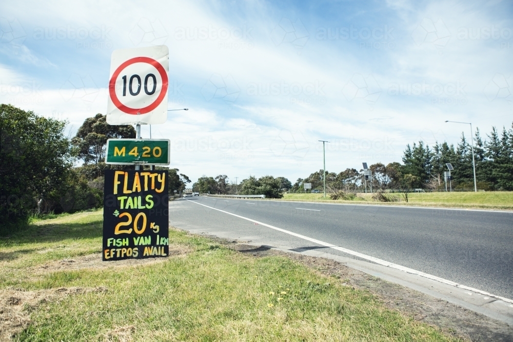 Orange and yellow roadside sign advertising flathead tails horizontal - Australian Stock Image