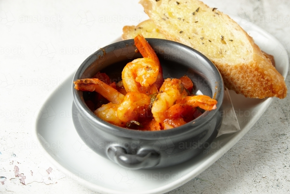 Orange buttered shrimp in a pot - Australian Stock Image
