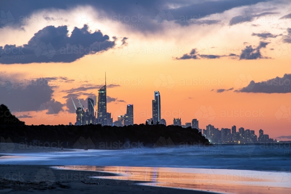 Orange colours of the sky with the Gold Coast city buildings in the distance. - Australian Stock Image