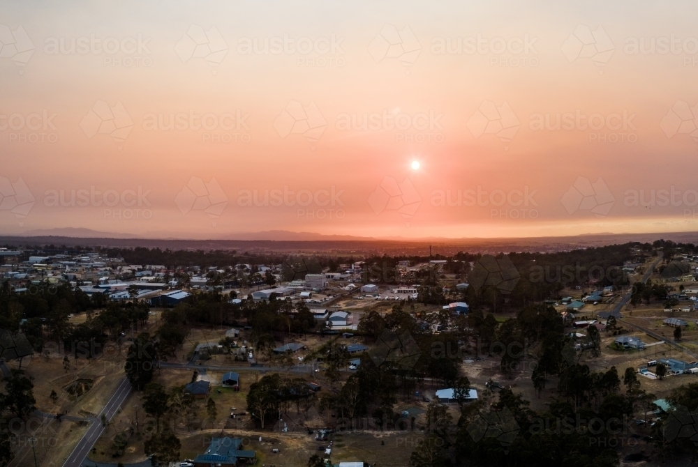 Orange sunrise through smoke overlooking houses and Maison Dieu industrial area - Australian Stock Image