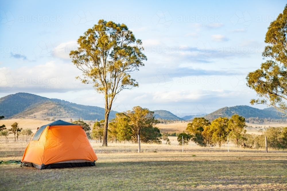 Orange tent set up in a farm paddock - Australian Stock Image