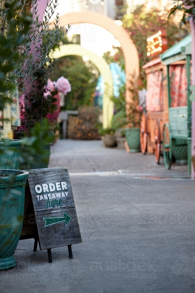 Order takeaway sign in restaurant alleyway - Australian Stock Image