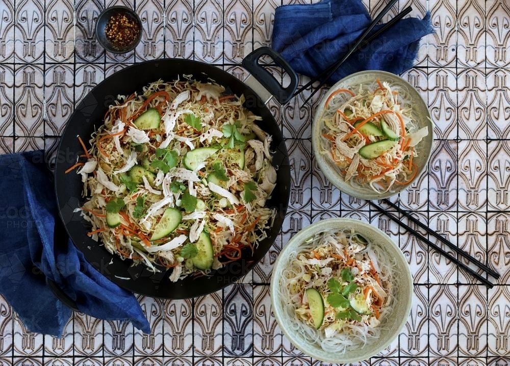 Oriental style chicken and noodle dish seen from above - Australian Stock Image