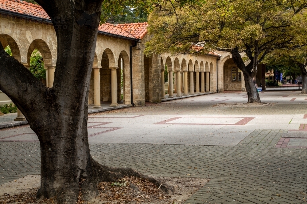 Ornate stone arch walkway and courtyard. - Australian Stock Image
