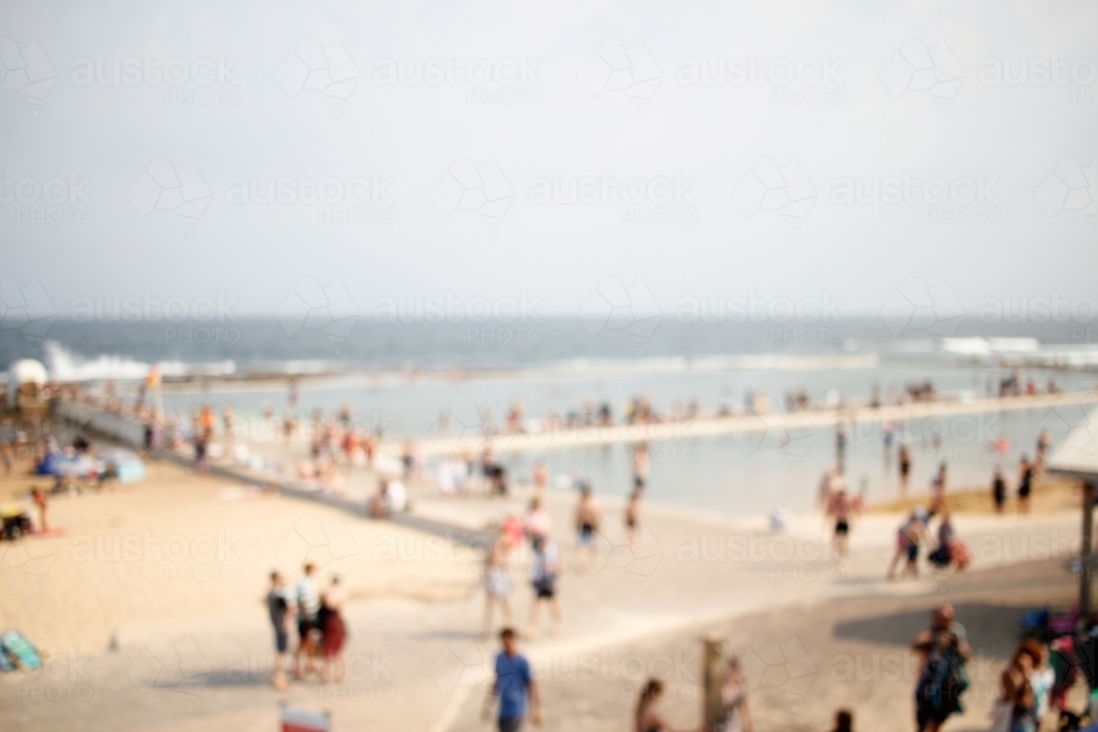 Out-of-focus photo of crowded beach in Newcastle NSW on a summer's day - Australian Stock Image