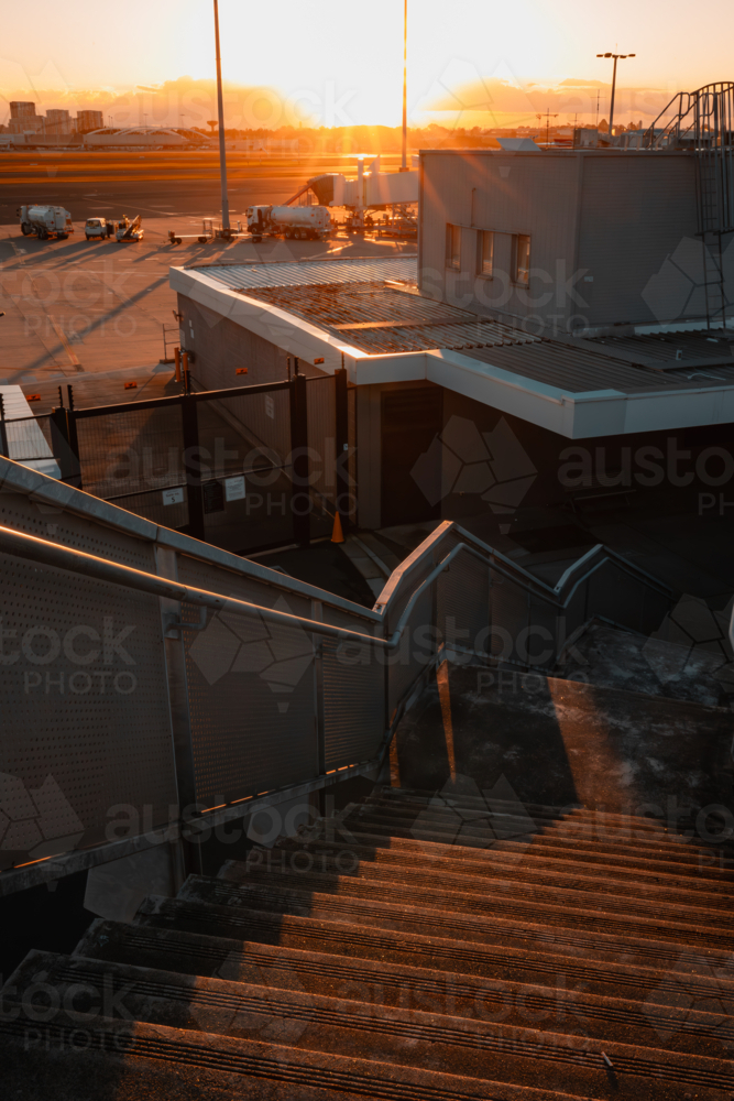 Outdoor staircase at Sydney Airport with runway in background - Australian Stock Image