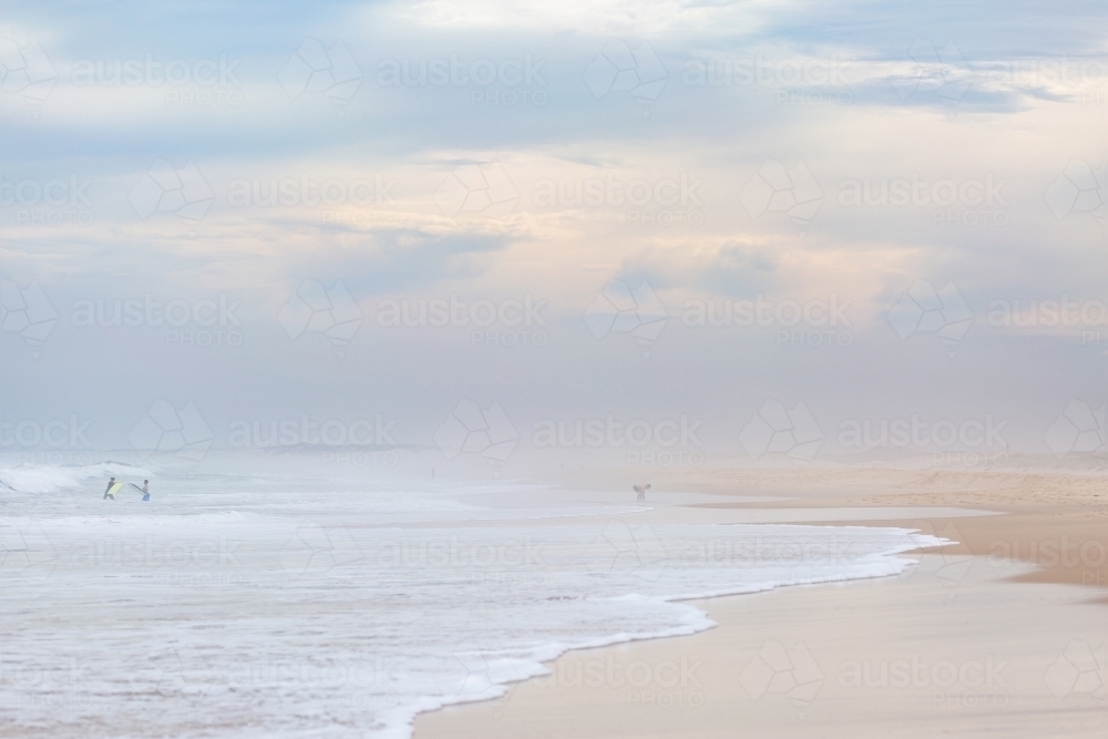 Overcast beach day with hazy sea spray filled sky - Australian Stock Image