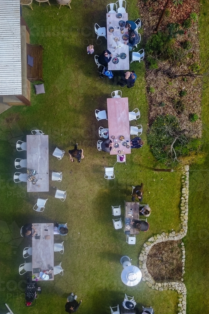 overhead aerial of outdoor cafe tables with people - Australian Stock Image