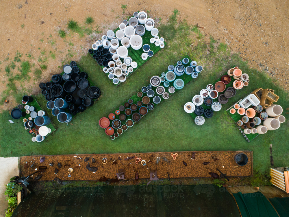 overhead aerial view of stacked pots for sale at nursery - Australian Stock Image