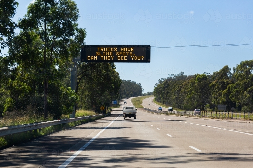 Overhead digital sign reading trucks have blind spots can they see you? - Australian Stock Image