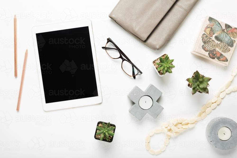 Overhead flat lay collection of desktop fashion and home items with negative space - Australian Stock Image
