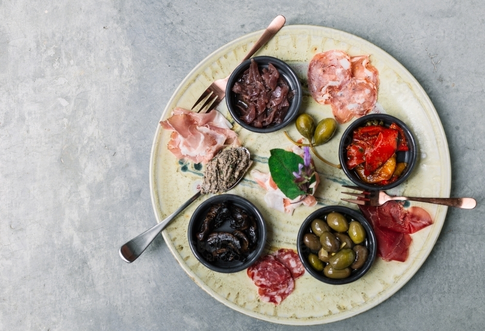 Overhead image of antipasto platter on concrete table - Australian Stock Image