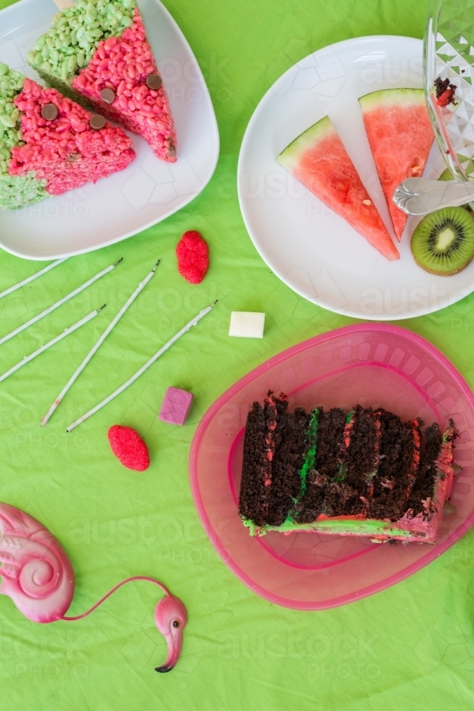 overhead of watermelon theme party, including cake, watermelon, lollies - Australian Stock Image