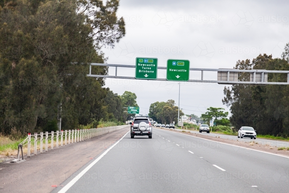 Image of Overhead road sign with directions to Newcastle, Taree and