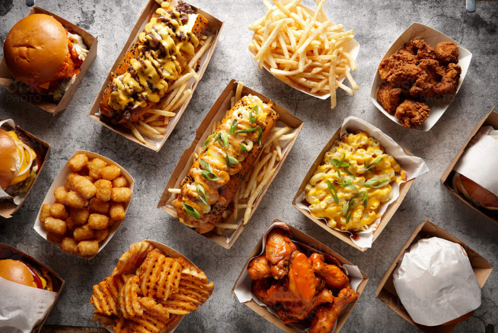 Overhead shot of different fried food dishes on a flat surface - Australian Stock Image