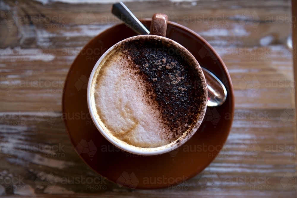 Overhead shot of freshly made coffee with wooden background - Australian Stock Image