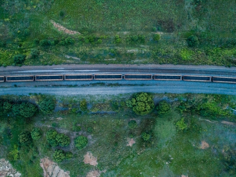 Overhead shot of full coal train passing buy on railway tracks - Australian Stock Image