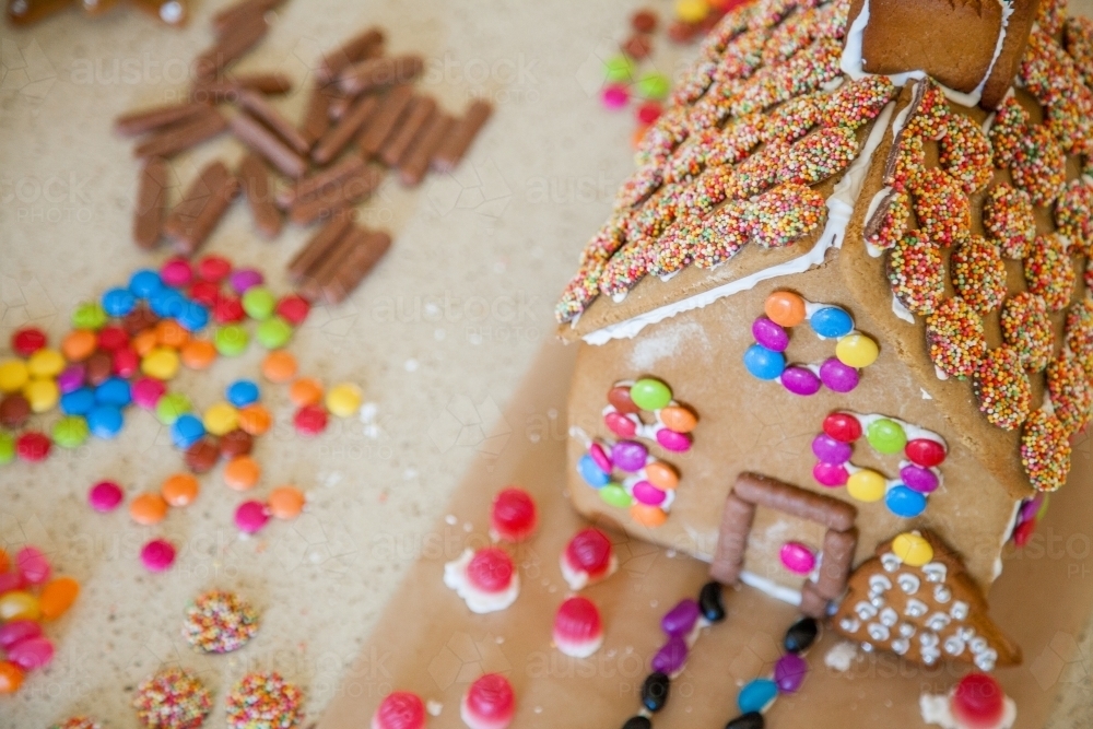 Overhead shot of gingerbread house and brightly coloured lollies - Australian Stock Image