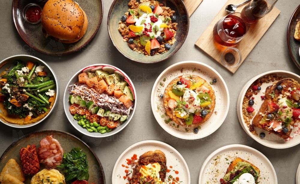 Image of Overhead shot of multiple food dishes on table Austockphoto