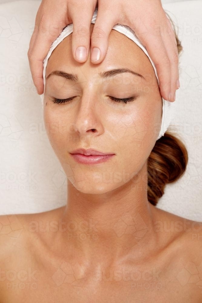 overhead view of a woman's clean face during a facial - Australian Stock Image
