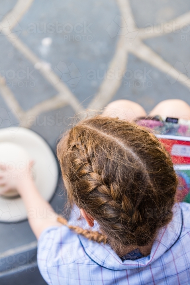 overhead view of australian high school student, focus on braided hair - Australian Stock Image