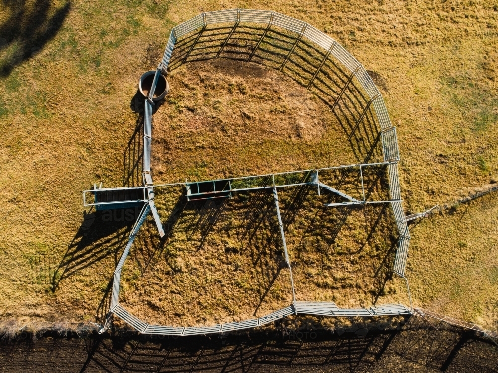 Overhead view of cattle yard in sunlight on farm - Australian Stock Image