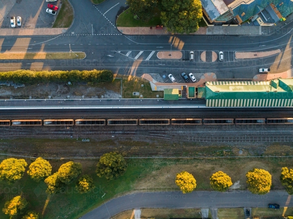 overhead view of coal train passing station in morning light - Australian Stock Image