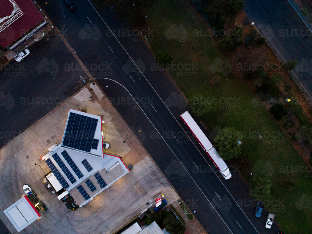 overhead view of country petrol station at dusk with truck parked on opposite side of road - Australian Stock Image