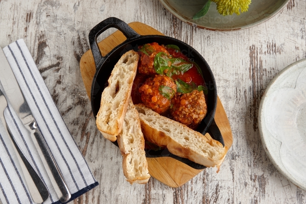 Overhead view of meatballs and bread meal on table - Australian Stock Image