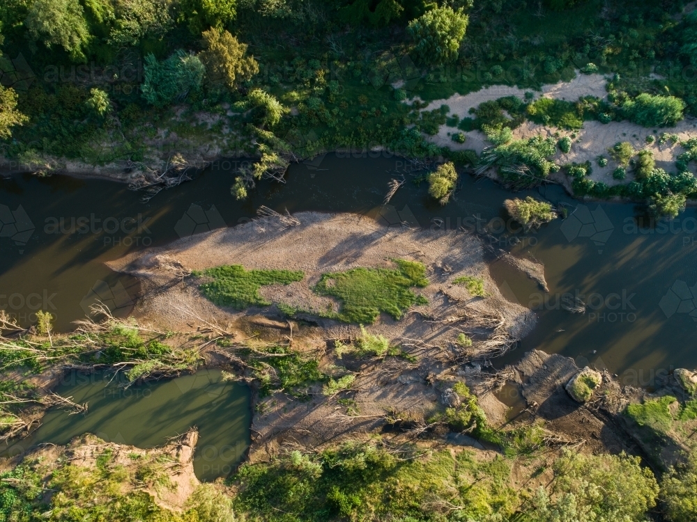 Overhead view of mudbank in brown river - Australian Stock Image