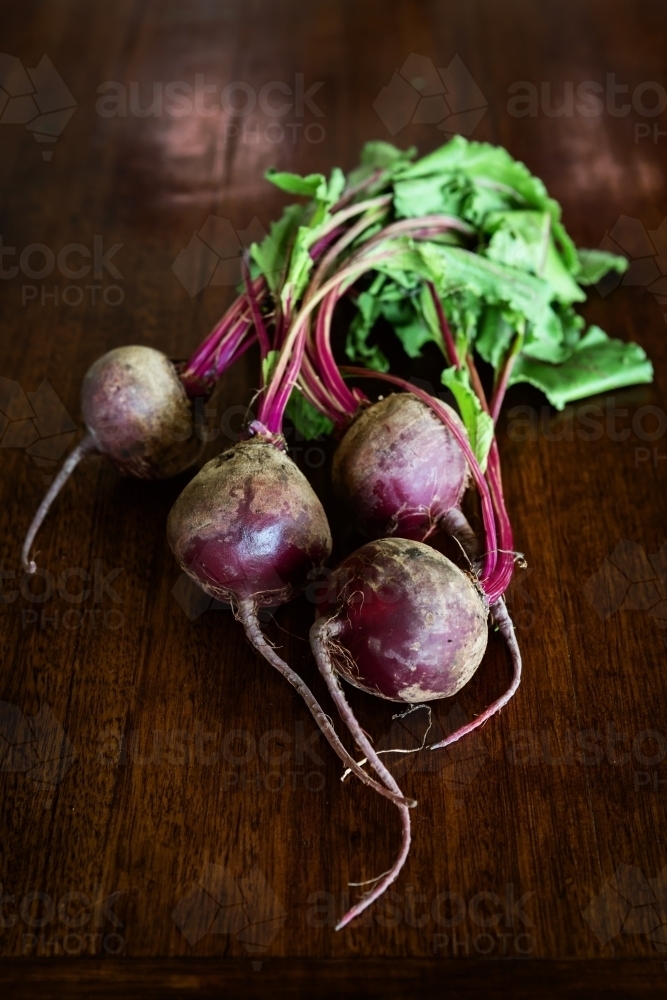 Overhead view of raw beetroots with leaves left on - Australian Stock Image