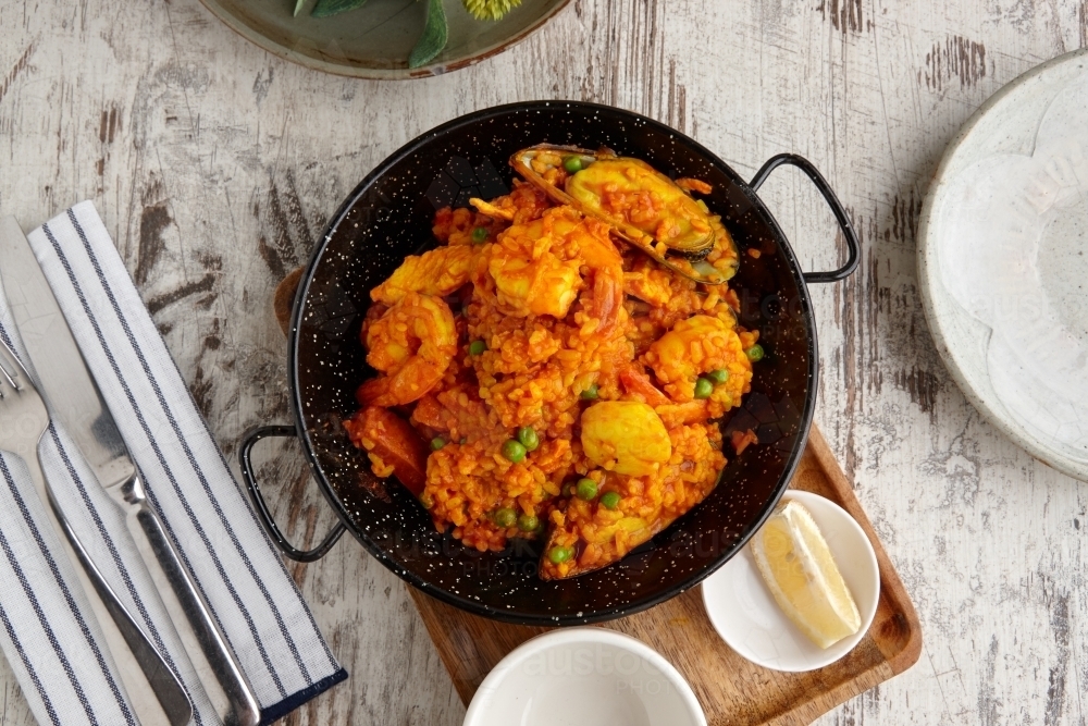 Overhead view of seafood paella on table - Australian Stock Image