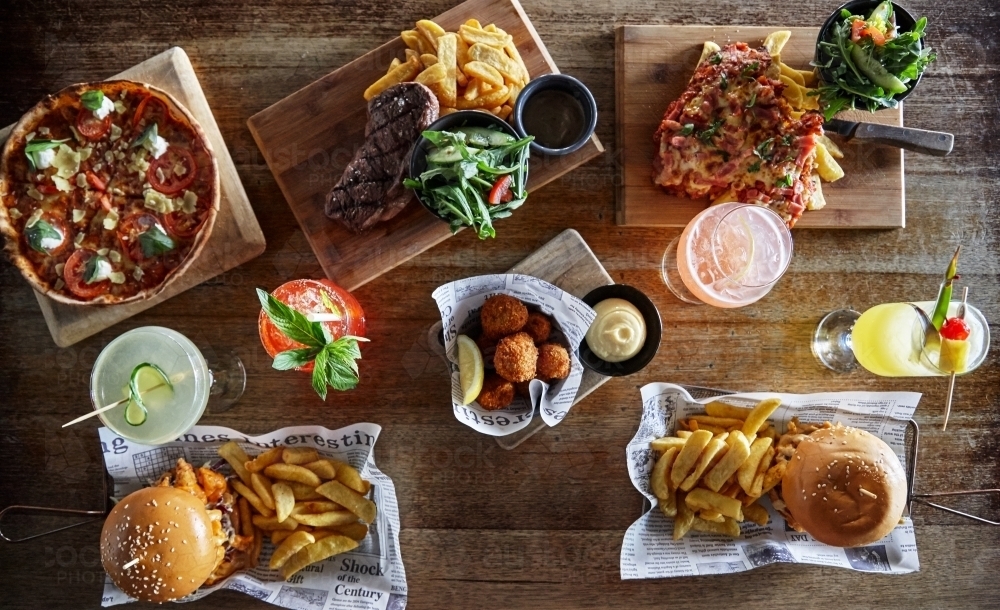 Overhead view of various take away meals and drinks on table - Australian Stock Image