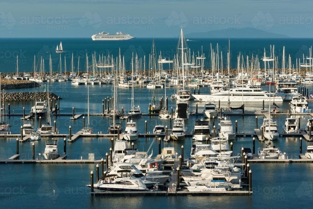 Overhead view of white boats moored to piers on blue ocean - Australian Stock Image