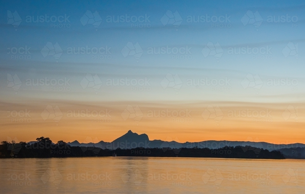 Overlooking the river at sunset to a mountain range. - Australian Stock Image