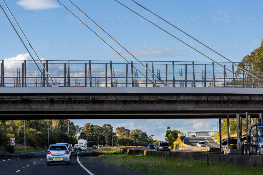Image of Overpass over divided highway with on ramp - Austockphoto